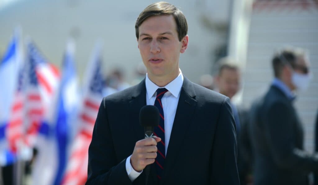 Jared Kushner speaking outdoors in a suit.