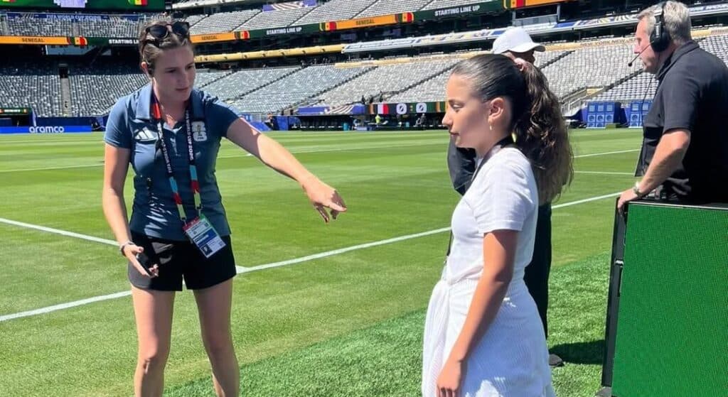 Ayala Ohana standing on the field at a World Cup stadium.