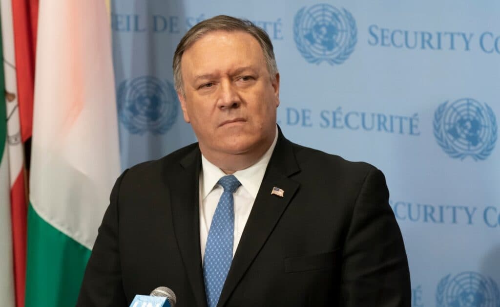 Mike Pompeo seated in front of a United Nations backdrop