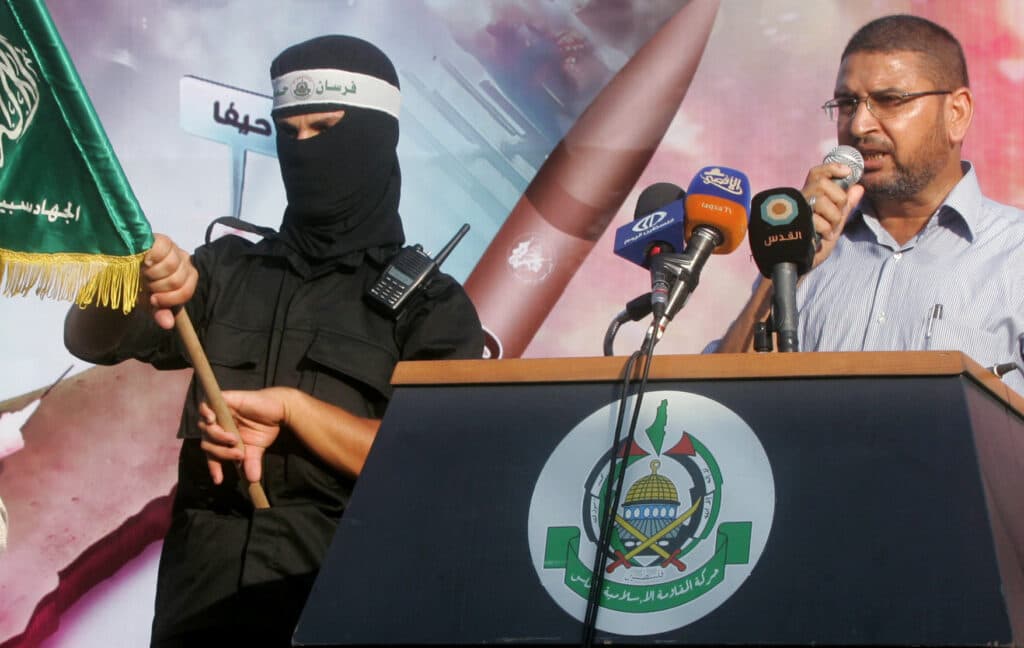 Palestinians hold posters of Hamas leader Ismail Haniyeh during a protest in Nablus.