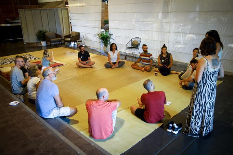 Nova survivors sitting in a circle during therapy session