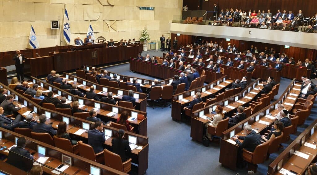 Israeli lawmakers seated inside the Knesset plenum during a parliamentary session.
