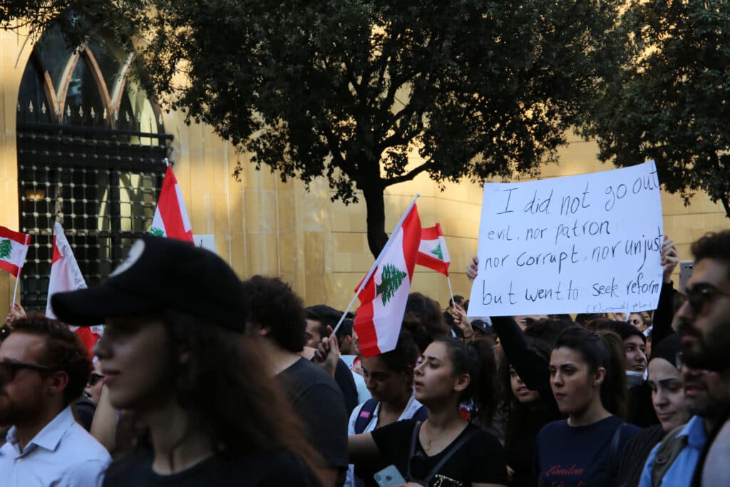 Lebanese protesters holding Lebanese flags during a demonstration in Beirut’s Martyrs’ Square.