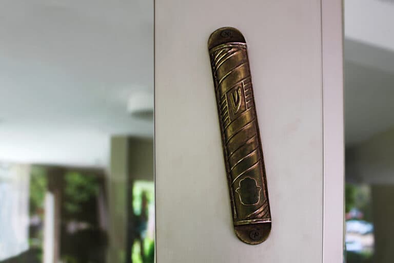 Silver mezuzah on doorpost in home