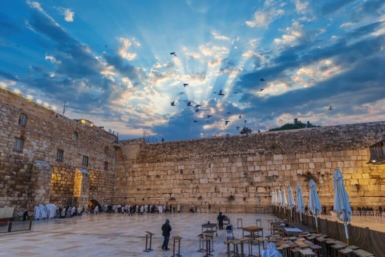 Sunrise at the Western Wall, blue sky with clouds and sun rays