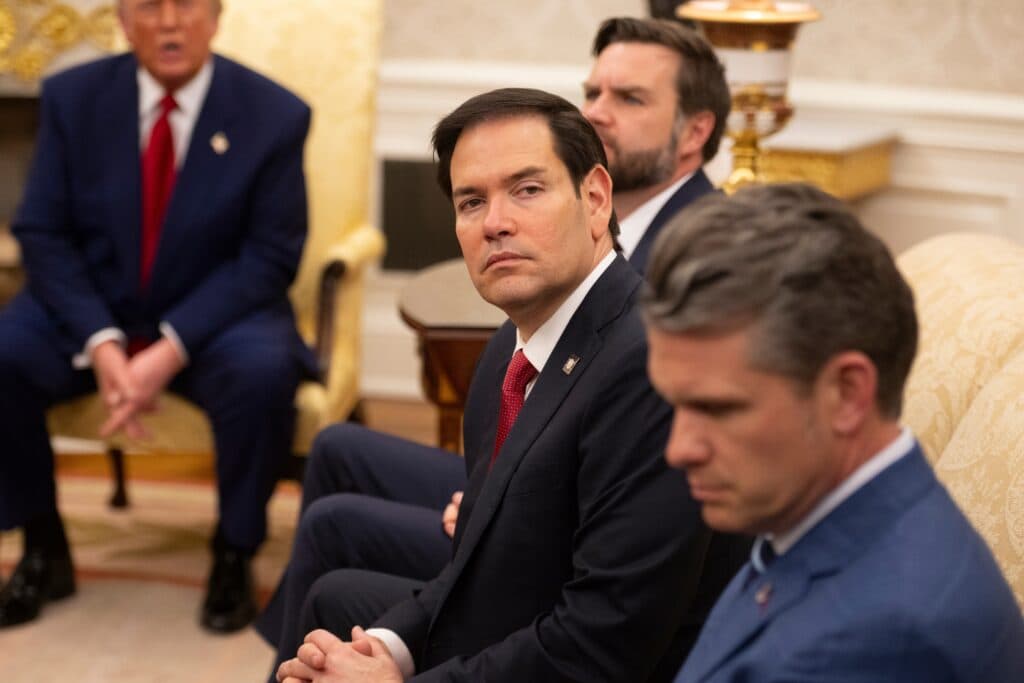 Senior U.S. officials seated during a White House meeting.