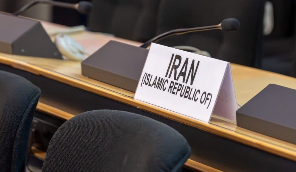 Iran delegation sign at a diplomatic negotiation table