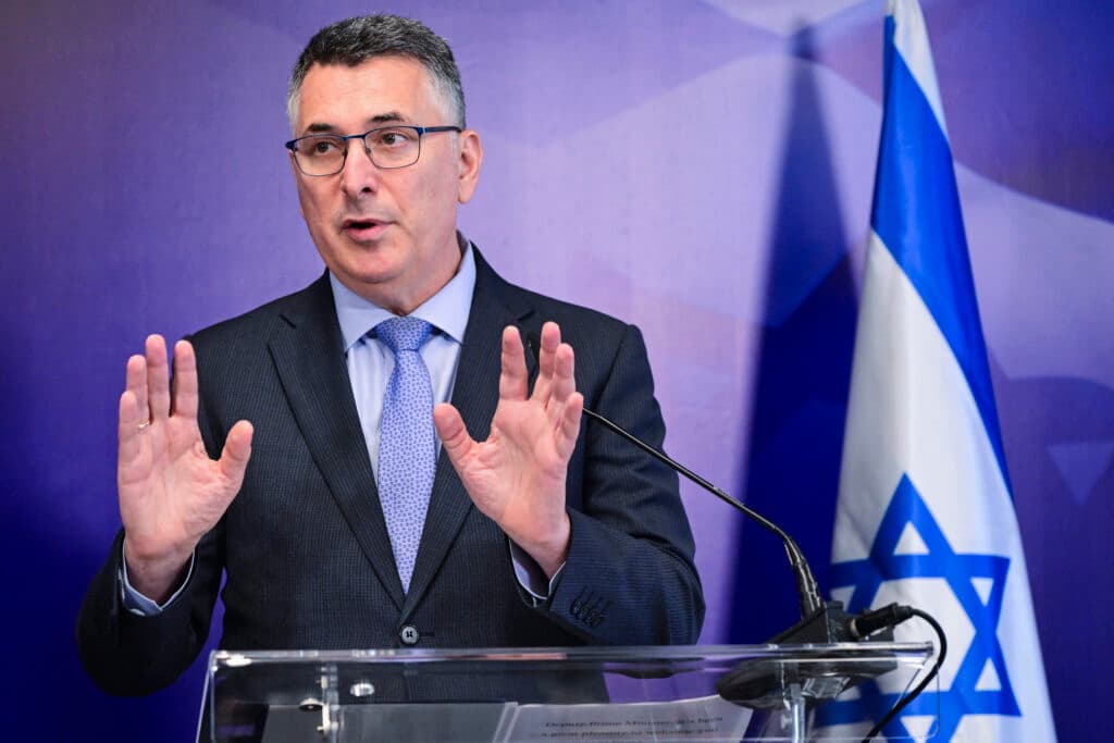 Israeli Foreign Minister Gideon Sa’ar speaking at a podium beside an Israeli flag.