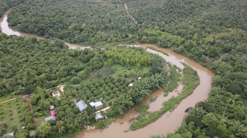 Aerial view of floodwaters surrounding homes and forested land in Rasuwa, Nepal, near the Tibet border.