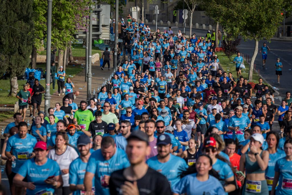 Thousands of runners taking part in the annual Jerusalem Marathon near the Old City walls.