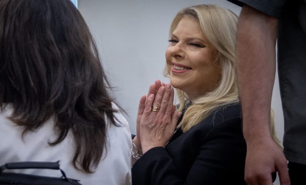 Sara Netanyahu smiles during a court hearing in Jerusalem.