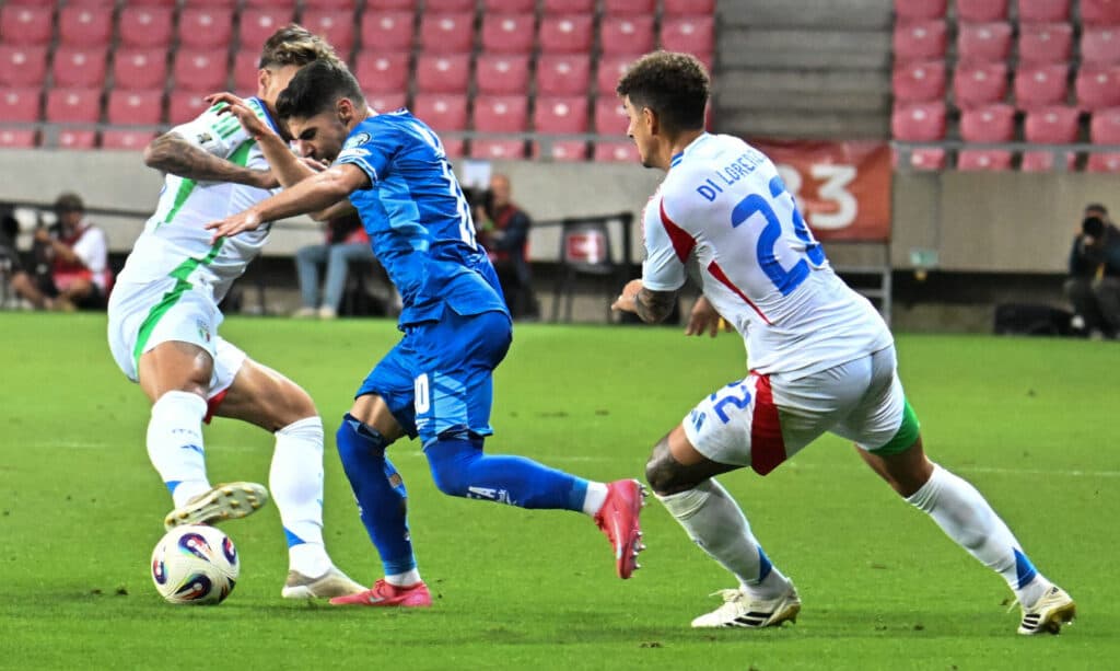 Israeli and Italian soccer players compete for the ball during a World Cup qualifier.