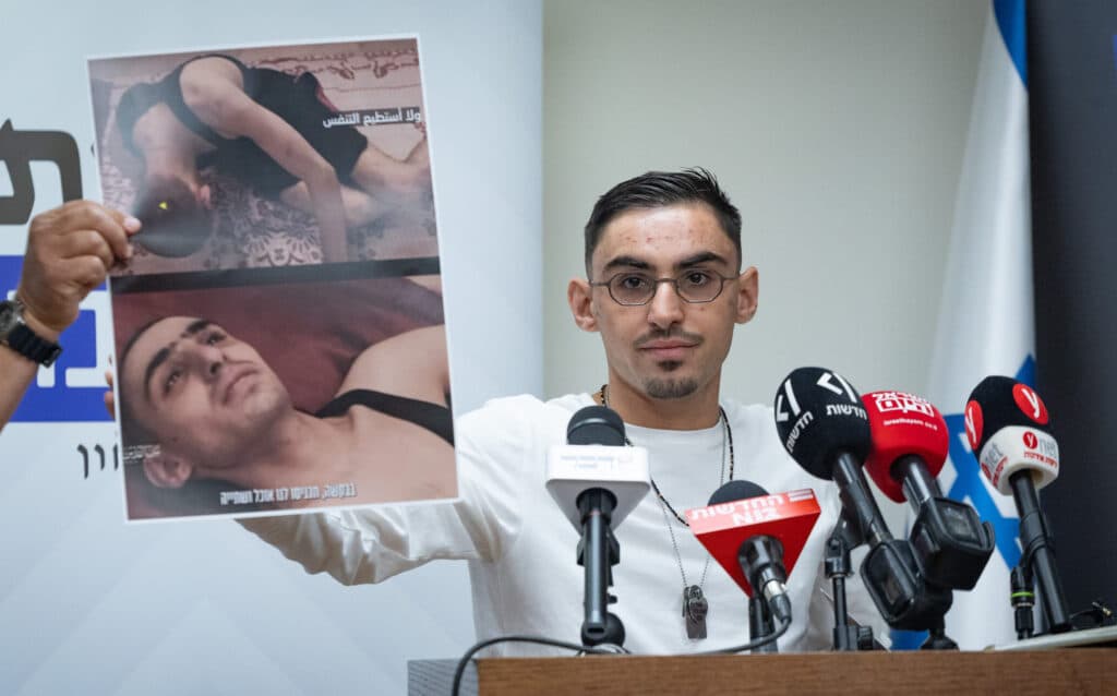 Former hostage Rom Braslavski speaking at a Knesset press conference.