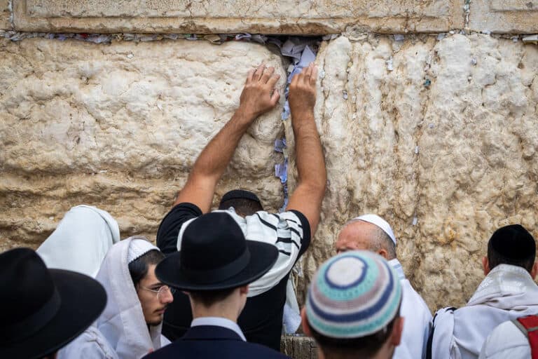 Different sizes, colors and styles of kippahs worn by Jews who are praying at the Western Wall