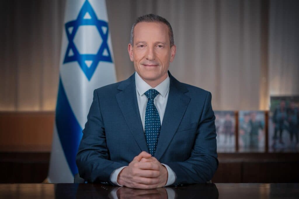 Amir Baram seated in front of an Israeli flag in an official Ministry of Defense portrait.