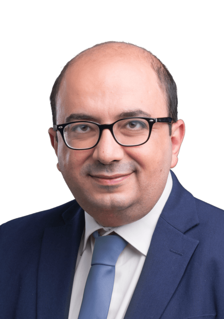 Sami Abu Shehadeh wearing glasses, a suit, and a blue tie.