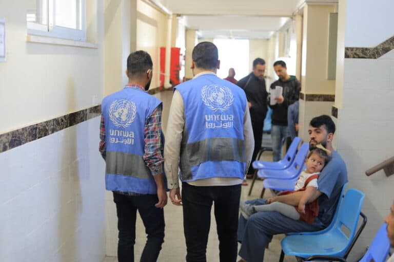 UN workers with blue UNRWA vests in gaza UNRWA facility