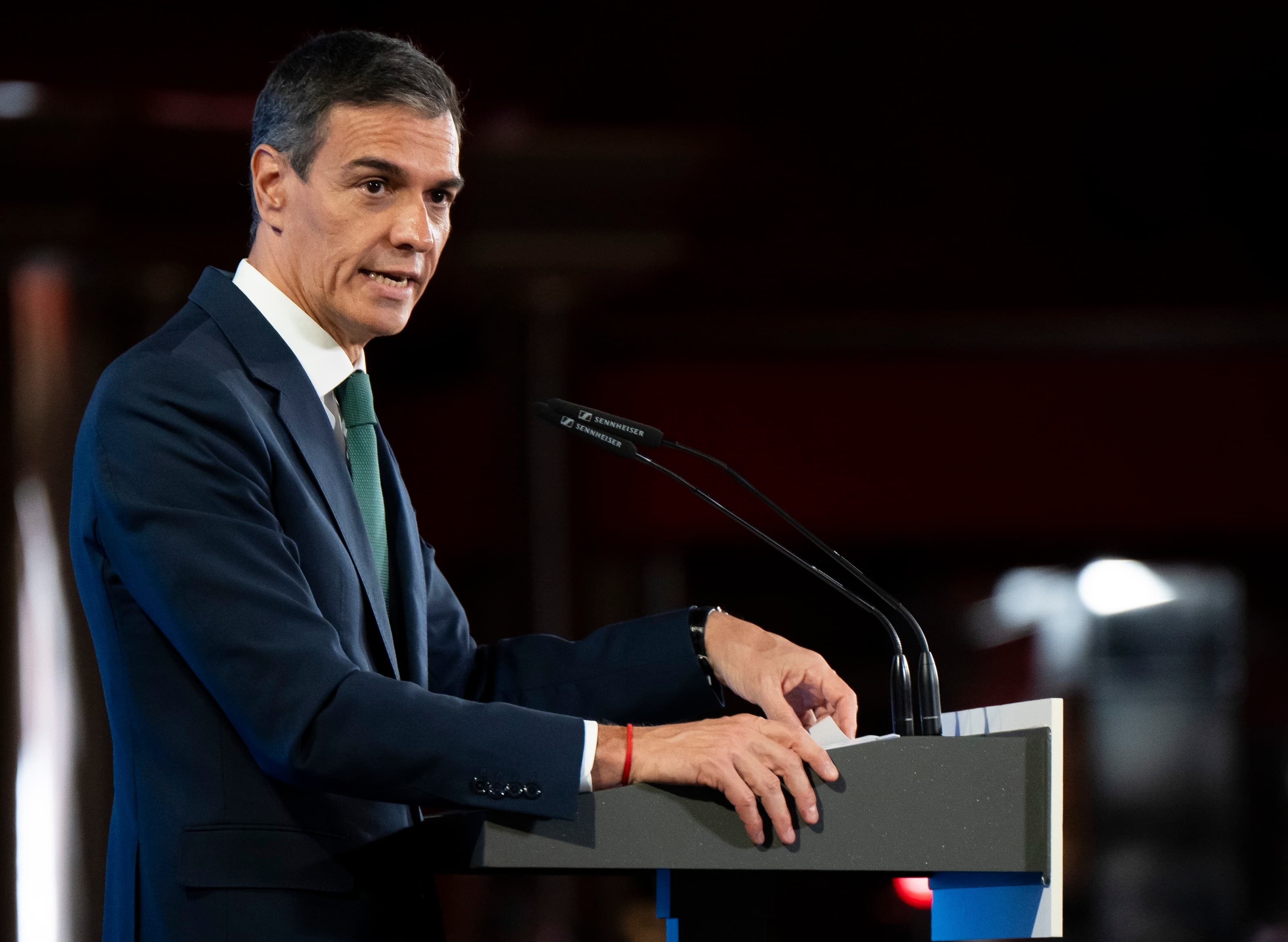 Spanish Prime Minister Pedro Sánchez speaks at a podium during an event in Madrid.