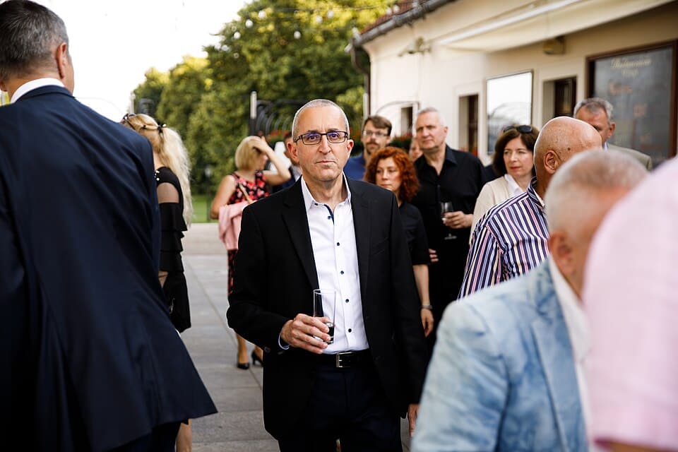 Israeli diplomat Zvi Aviner Vapni stands at an outdoor event.
