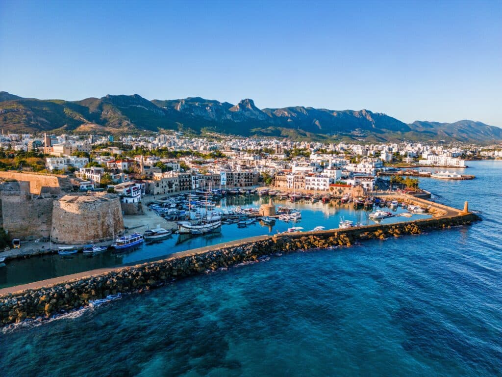 Kyrenia Harbour in North Cyprus with the Mediterranean coastline and surrounding city.