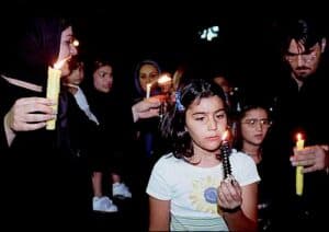 Iranians after 9/11 holding candles at a Tehran vigil for American victims.