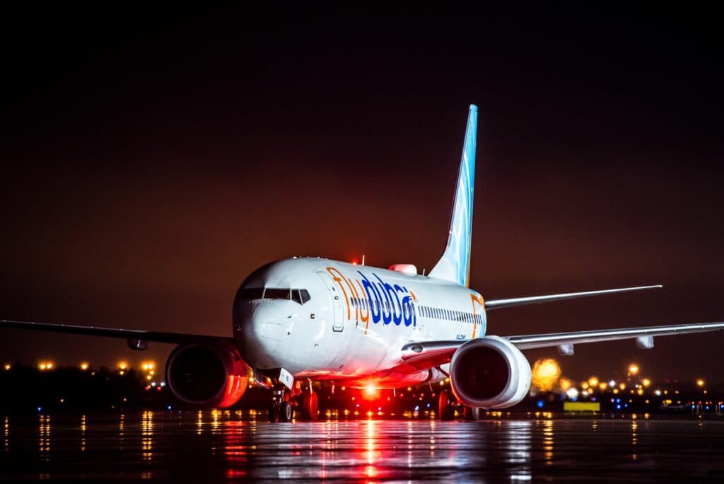 Flydubai Boeing 737 MAX 8 parked at night at Pulkovo International Airport in Saint Petersburg.