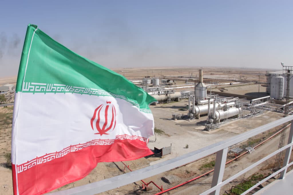Iranian flag flying beside an oil and gas facility in Iran.